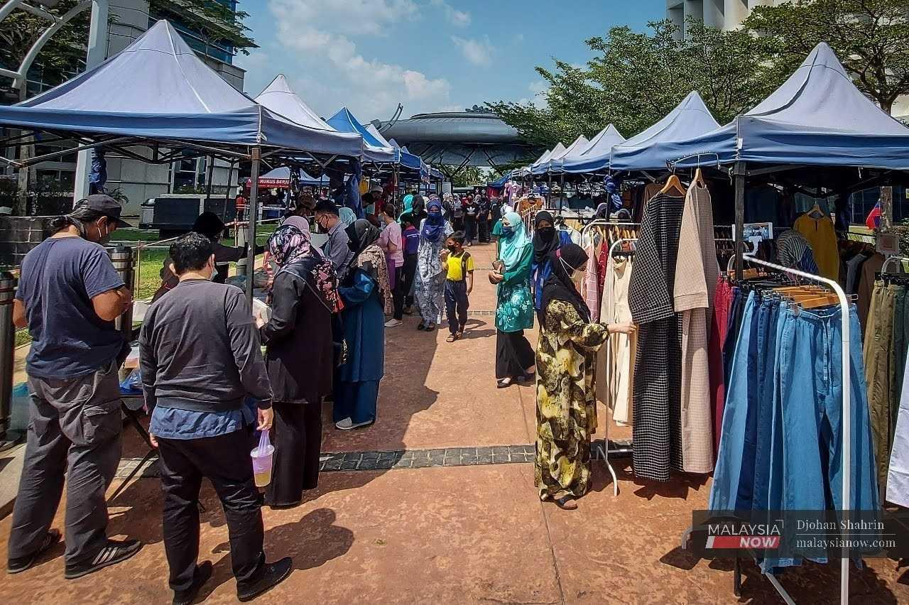 Civil servants mingle during their lunch break at stalls set up outside the Government Complex in Putrajaya.