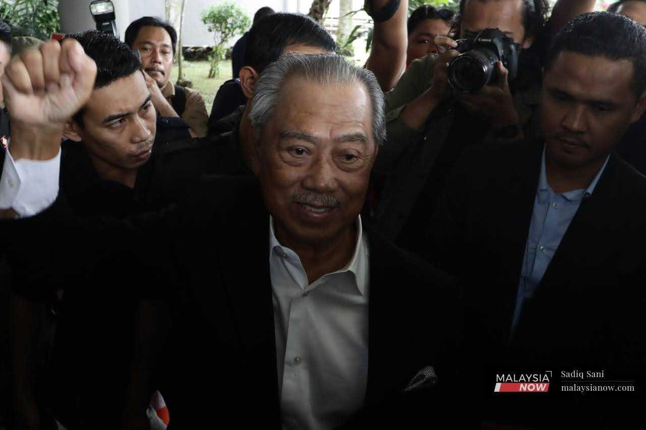 Former prime minister Muhyiddin Yassin leaves the Shah Alam court complex, March 13.