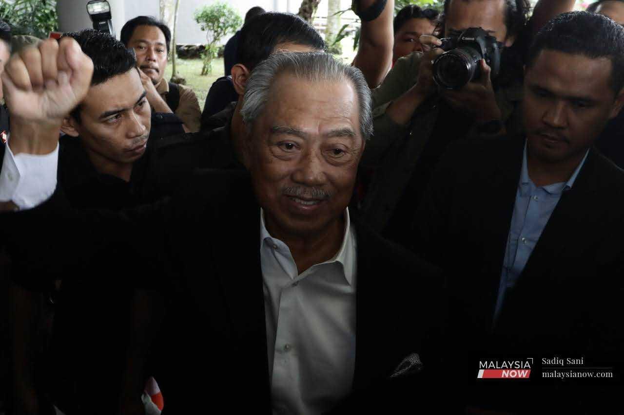 Former prime minister Muhyiddin Yassin leaves the Shah Alam court complex, March 13. 
