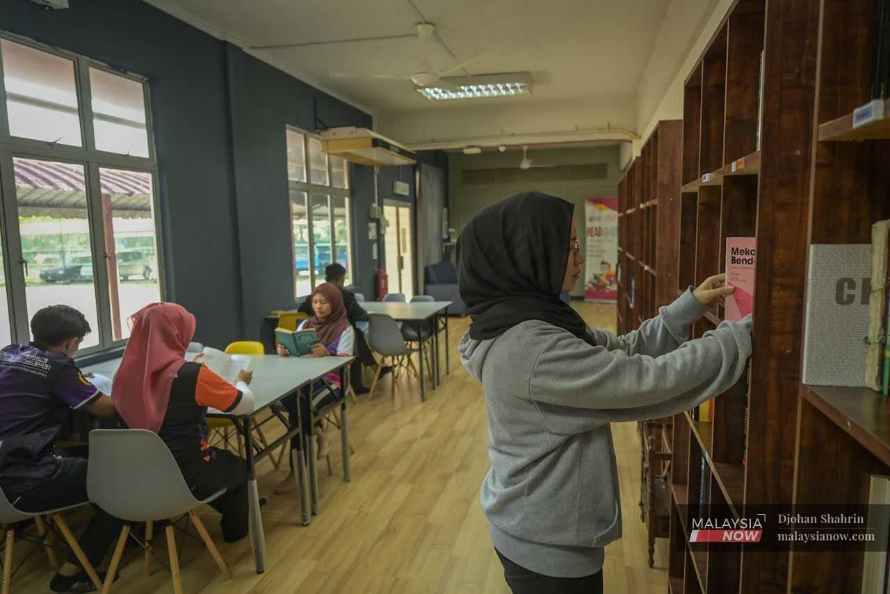 Students work at the library of a university in Selangor.