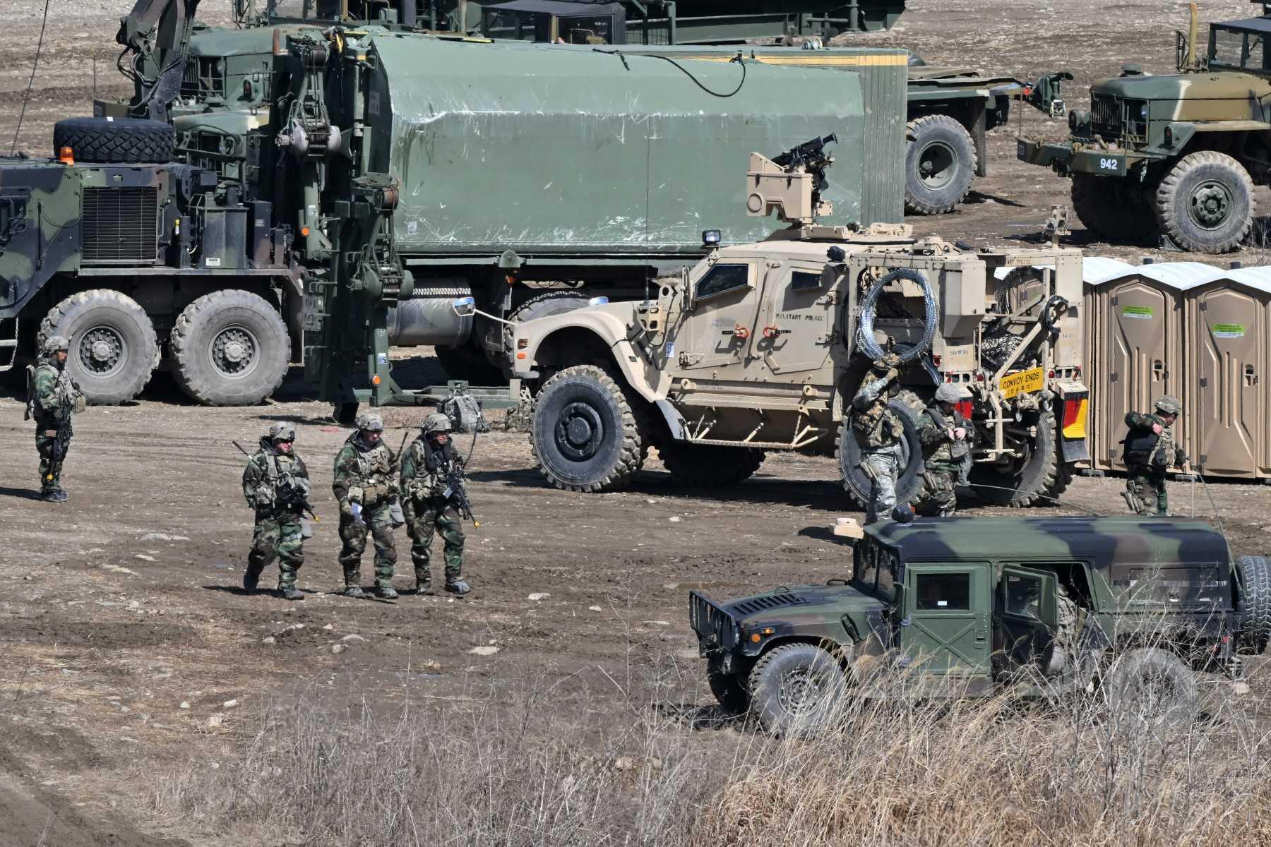 US soldiers walk past military vehicles at a military training field in the border city of Yeoncheon on March 13. Photo: AFP
