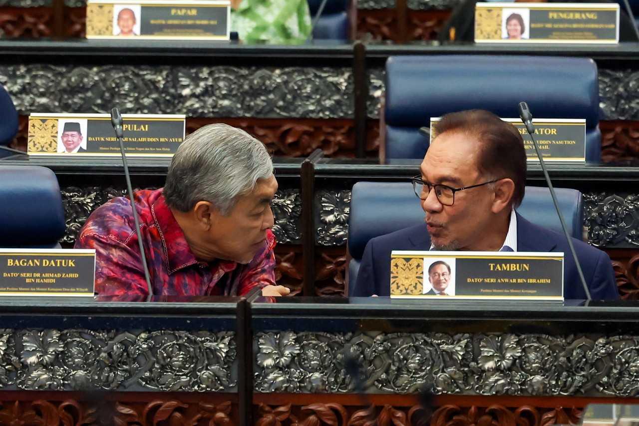 Prime Minister Anwar Ibrahim with his deputy, Ahmad Zahid Hamidi, in the Dewan Rakyat, Feb 16. Photo: Bernama