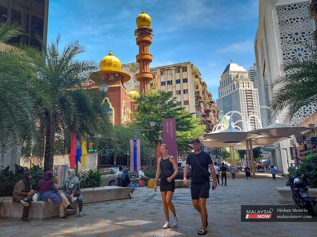Tourists make their way through the Masjid India area in the capital city of Kuala Lumpur. 
