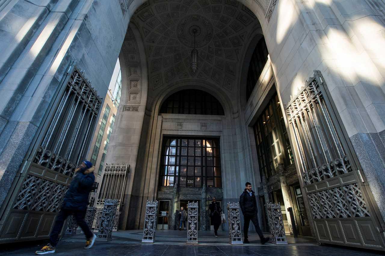 People exit the building where Credit Suisse bank has its headquarters in New York City, March 15. Photo: Reuters