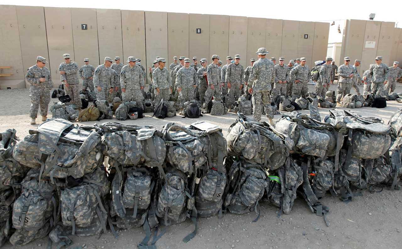 US soldiers wait to load their luggage as they prepare to pull out from Iraq and leave for Kuwait from Tallil Air Base near Nassiriya, southeast of Baghdad, Iraq, Aug 15, 2010. Photo: Reuters