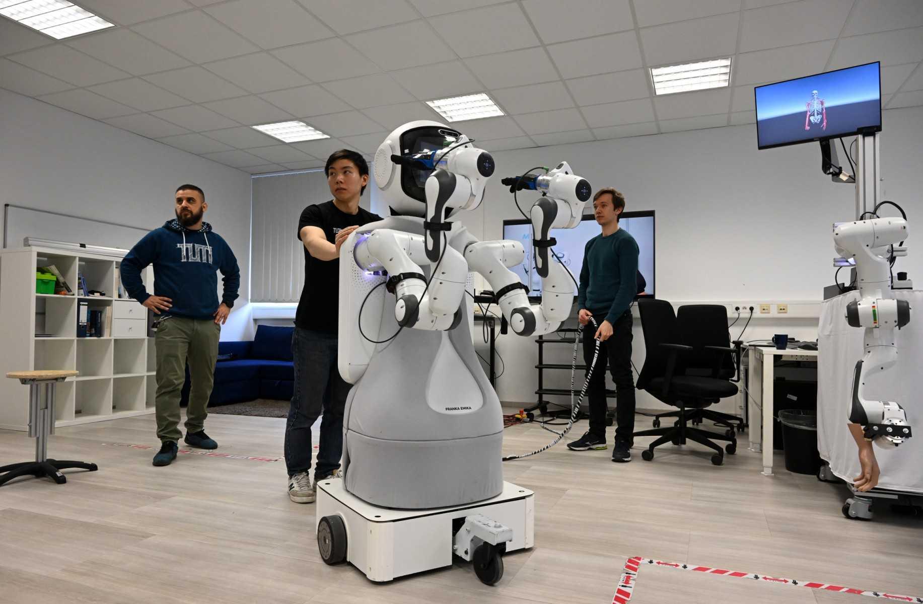 Employees work with the robot Garmi in the laboratory of the Research Center Geriatronics of the Technical University Munich, in Garmisch-Partenkirchen, southern Germany, on March 6. Photo: AFP