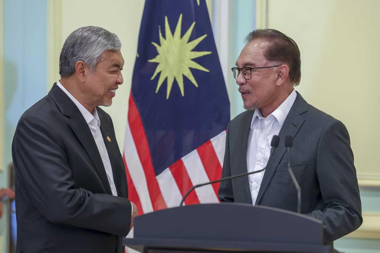 Prime Minister Anwar Ibrahim with his deputy Ahmad Zahid Hamidi at a press conference in Putrajaya on Dec 5. Photo: Bernama
