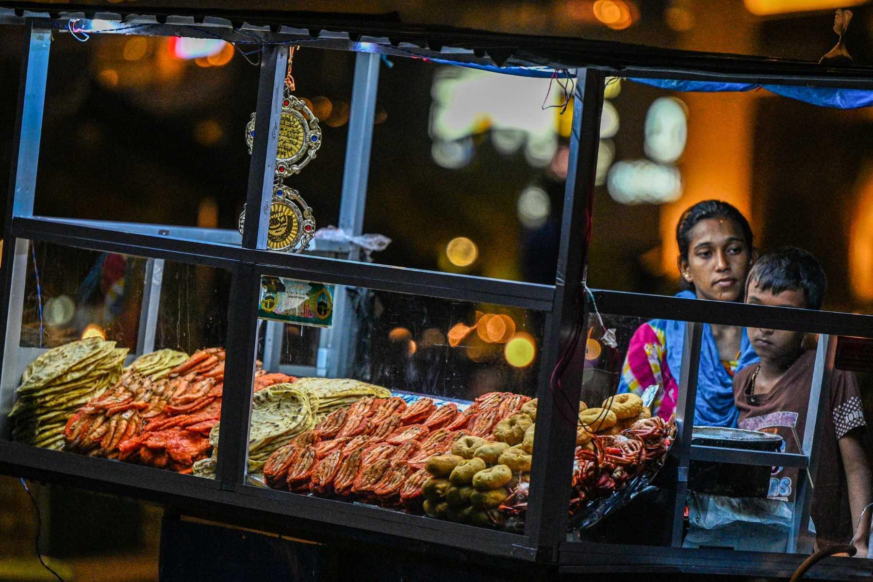 A street vendor sells prawns and sea-food at her kiosk at the Galle Face Beach in Colombo on March 20. Photo:  AFP 