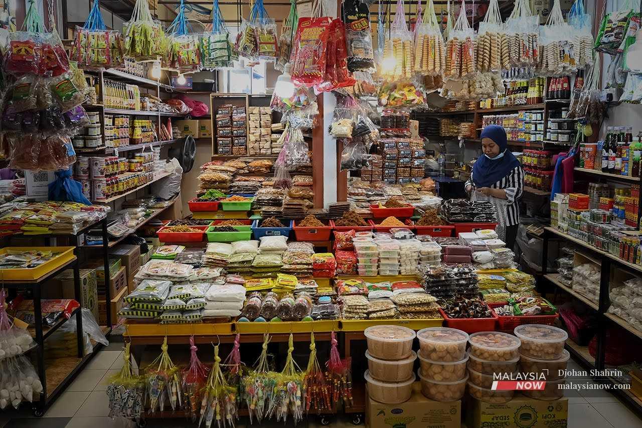 A kuih vendor waits at her shop in Pekan Rabu, Alor Setar in Kedah.