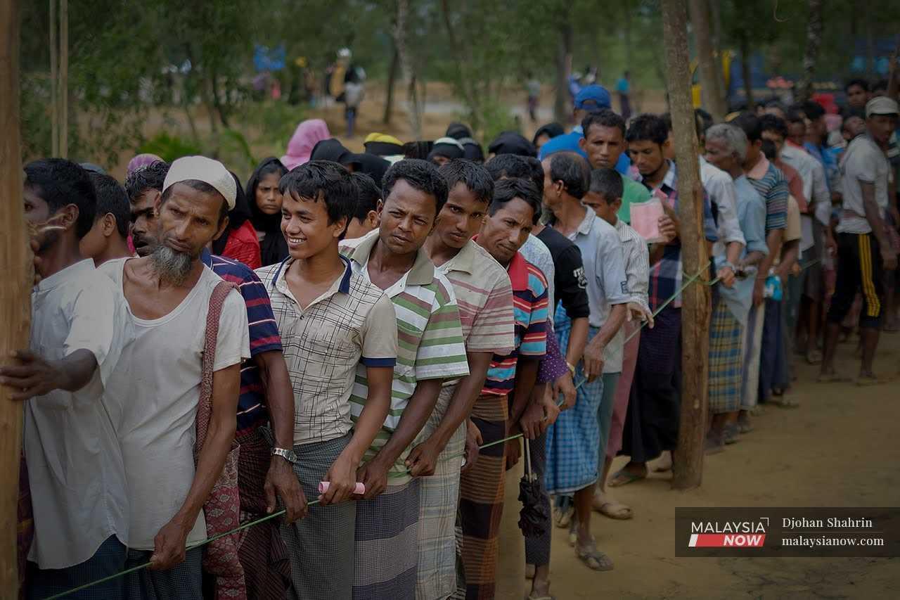 Rohingya refugees queue for food aid at the World Food Programme in the Cox Bazar camp in Bangladesh.