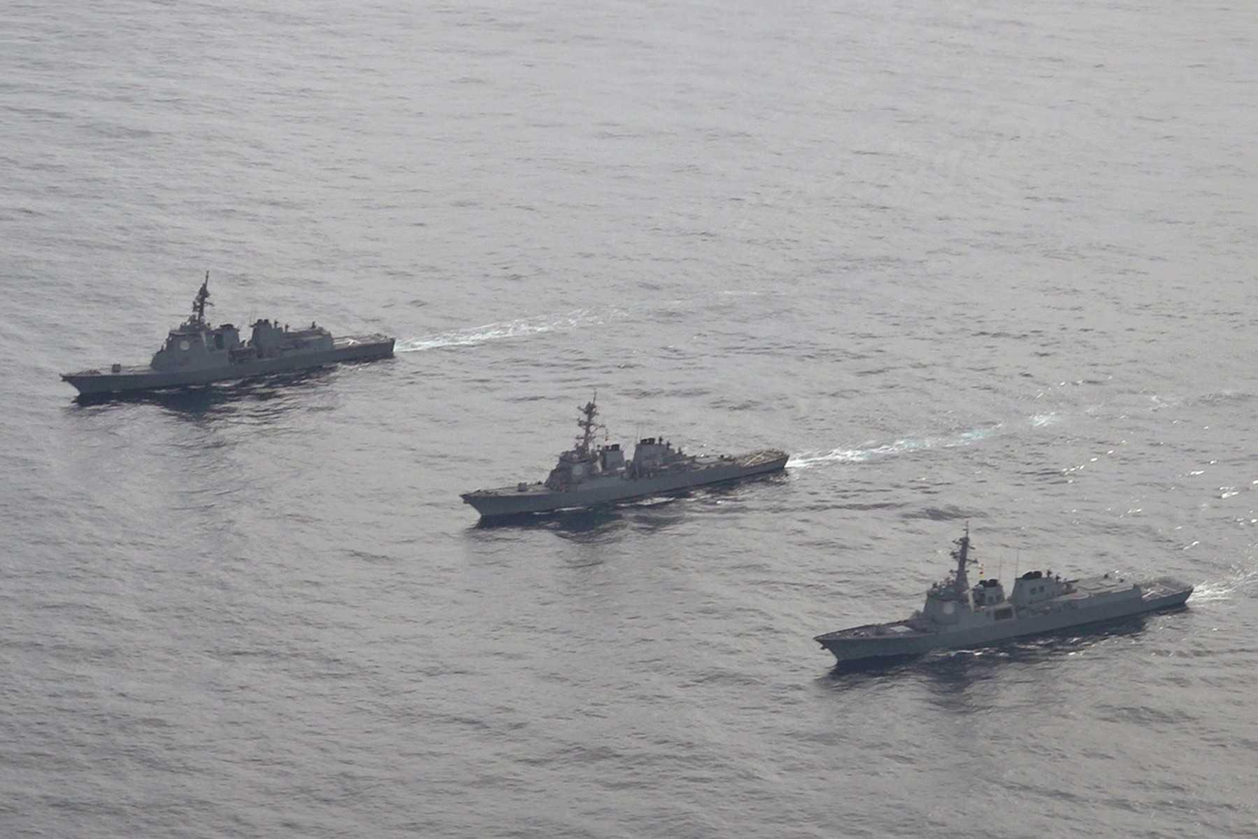 In this handout photo taken and released on Feb 22, the Japan Maritime Self-Defense Force's destroyer Atago (left), sails during a joint missile defence drill between South Korea, the US and Japan. Photo: AFP