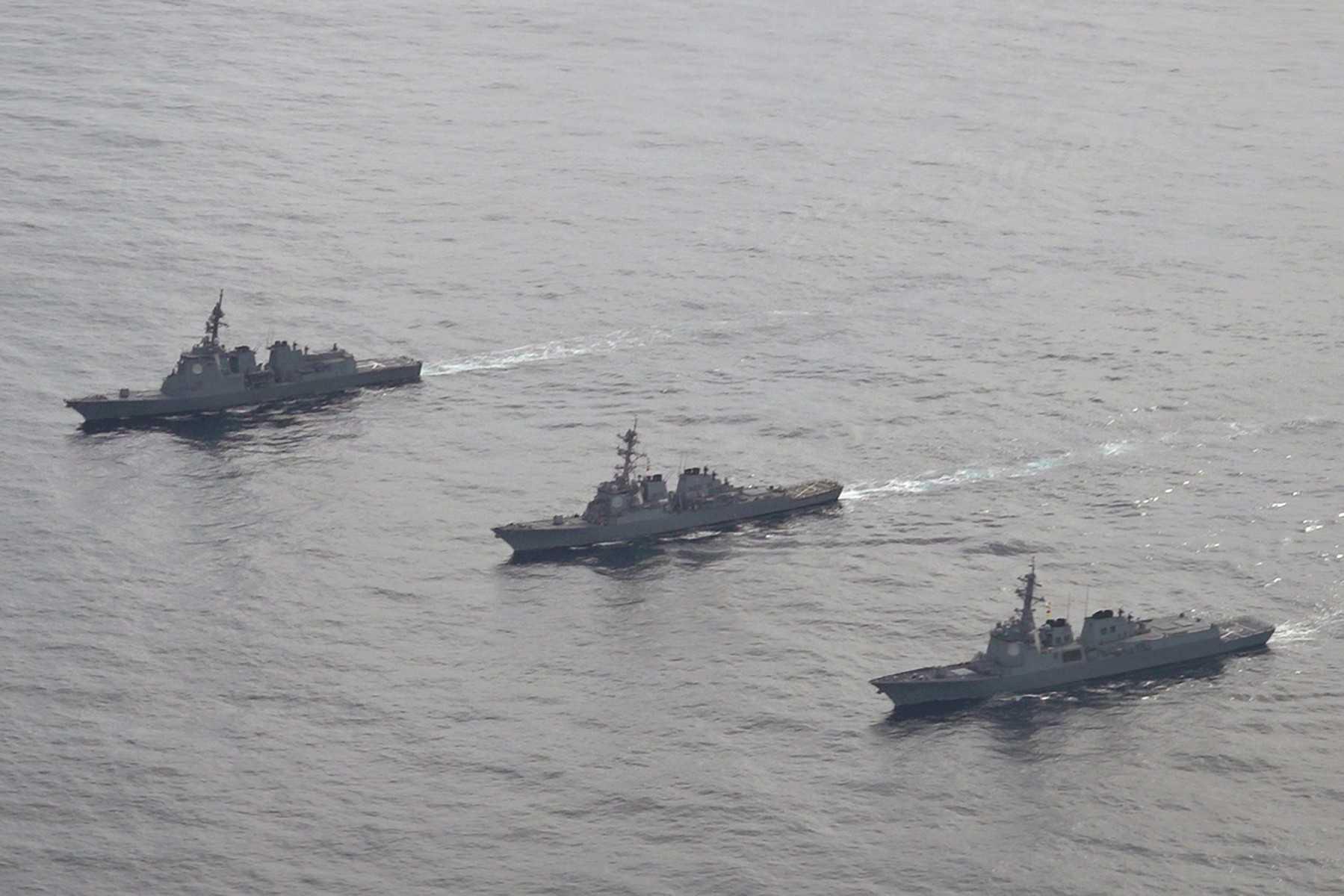 In this handout photo taken and released on Feb 22, the Japan Maritime Self-Defense Force's destroyer Atago (left), sails during a joint missile defence drill between South Korea, the US and Japan. Photo: AFP  