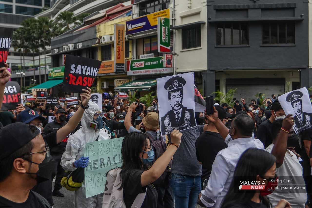 Protesters hold placards during the #TangkapAzamBaki rally last January in Bangsar, Kuala Lumpur, calling for Azam Baki's removal from the Malaysian Anti-Corruption Commission. 
