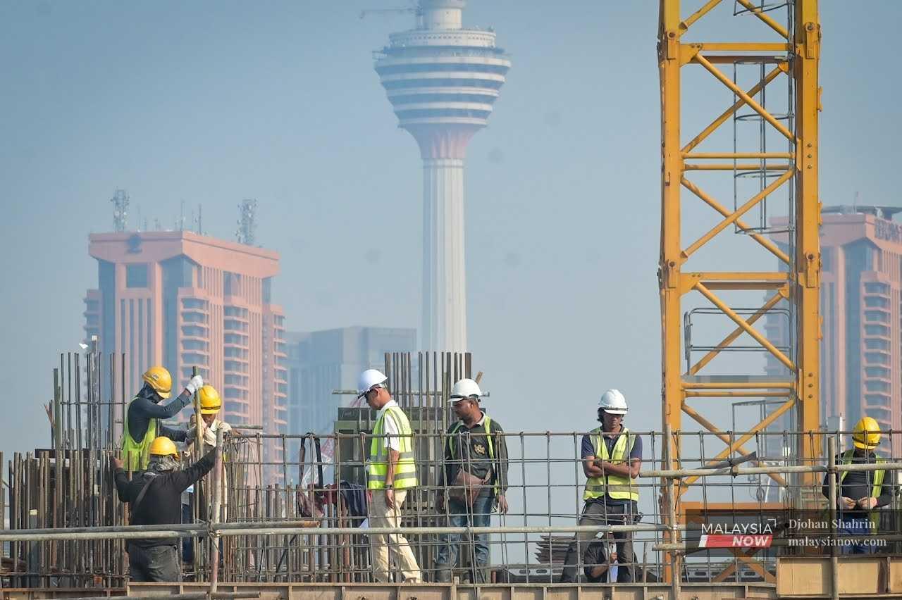 Contract workers at a construction site near the KL Tower in Taman Miharja, Kuala Lumpur.