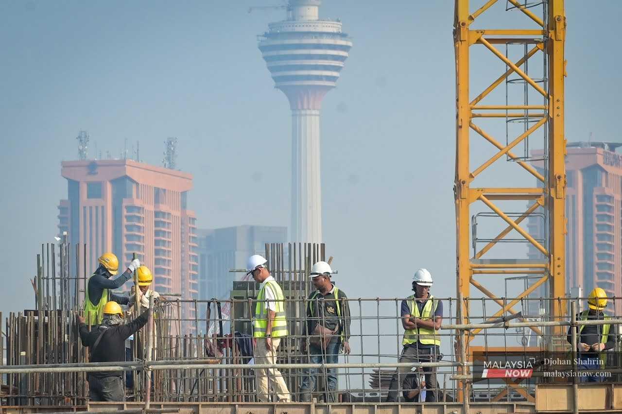Contract workers at a construction site near the KL Tower in Taman Miharja, Kuala Lumpur. 