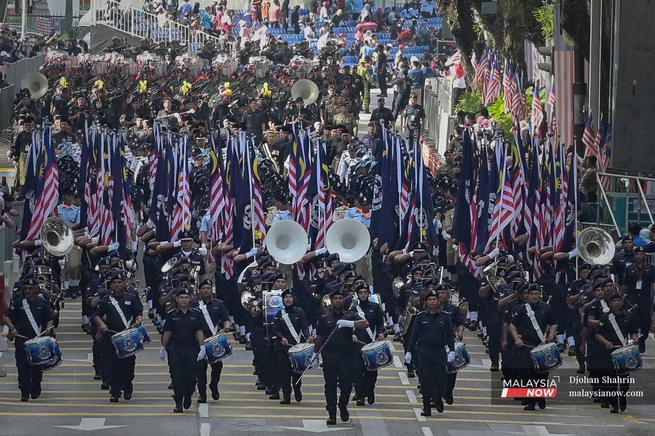 Members of the police force participate in a dress rehearsal for the 65th Merdeka Day celebration at Dataran Merdeka in Kuala Lumpur, Aug 29, 2022.