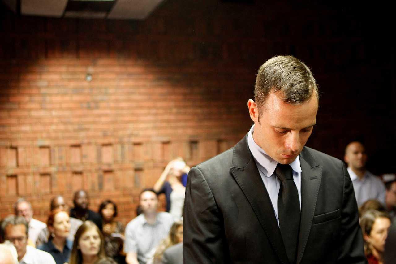 Oscar Pistorius stands in the dock during a break in court proceedings at the Pretoria Magistrates Court, Feb 20, 2013. Photo: Reuters