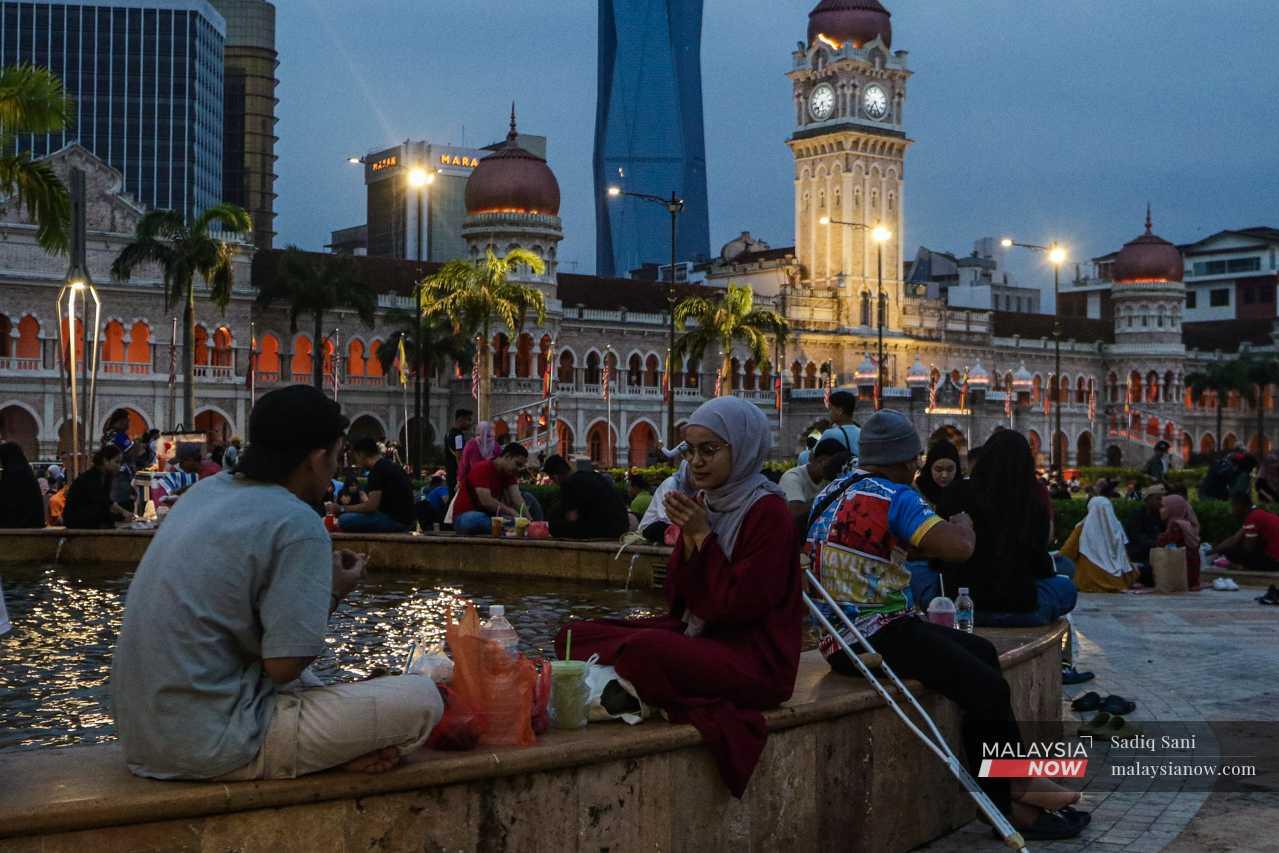 Muslims pray before breaking their fast at Dataran Merdeka in Kuala Lumpur. 