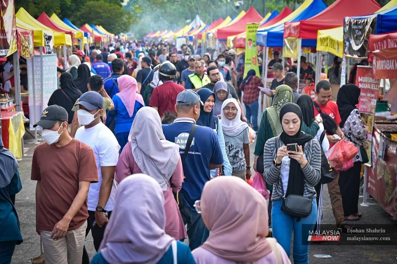People throng a Ramadan bazaar in Taman Tasik Permaisuri in Cheras – another traditional feature of the fasting month. 