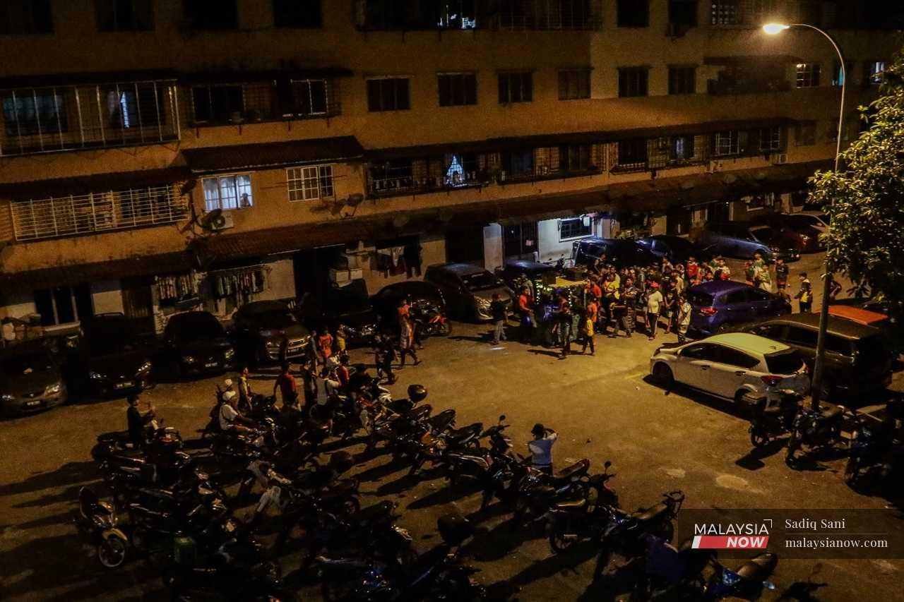 Youth gather at a flat in Taman Setia Balakong, singing religious songs and playing a drum to awaken Muslims for the pre-dawn meal. 
