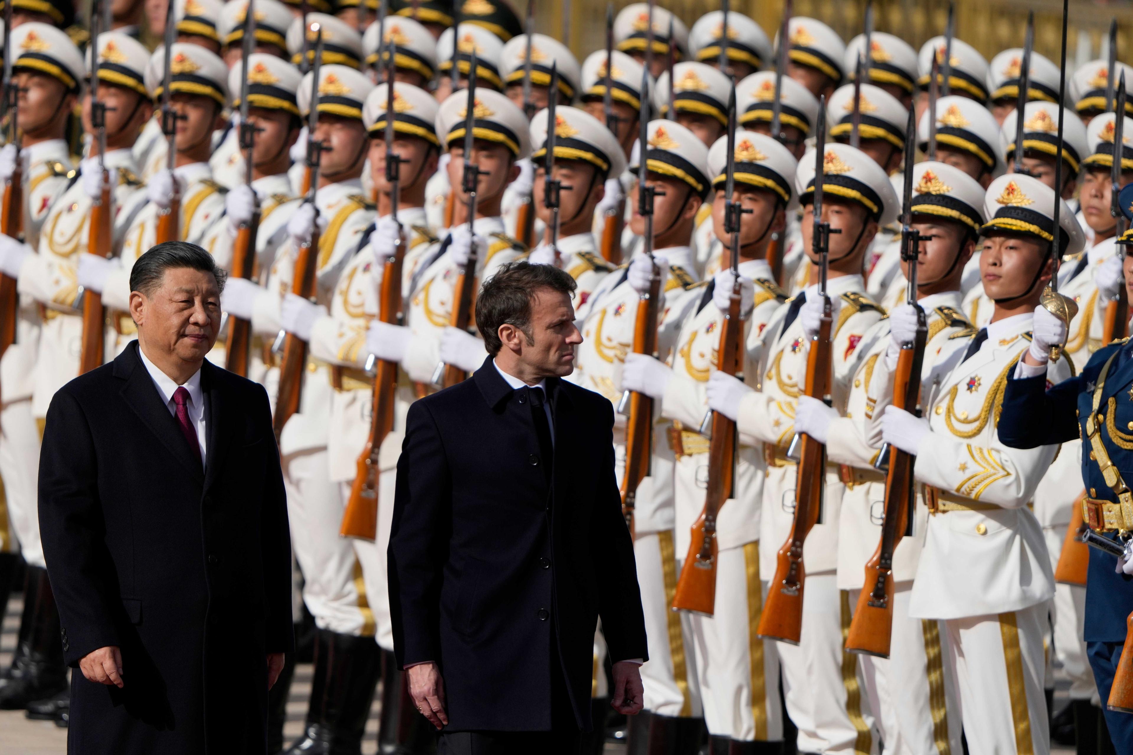 China's President Xi Jinping and his French counterpart Emmanuel Macron review a honour guard during the official welcoming ceremony in Beijing on April 6. Photo: AFP 