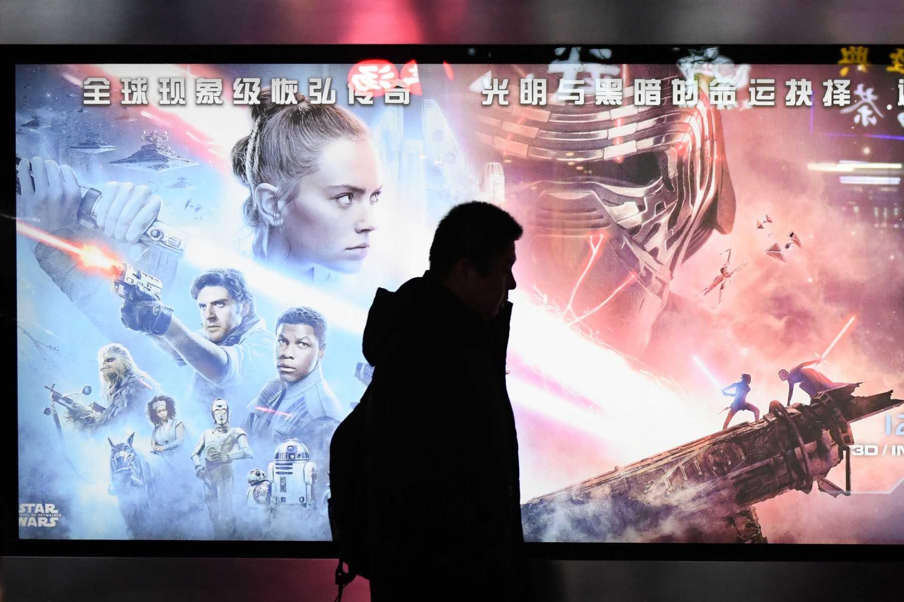 This photo taken on Dec 19, 2019 shows a man walking past a poster for the Star Wars movie, 'The Rise of Skywalker', in Beijing. Photo: AFP