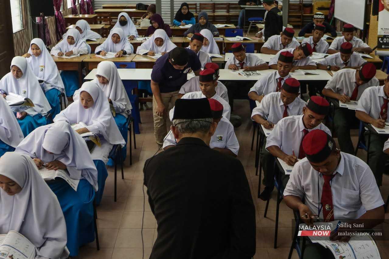 Students attend a class at Sekolah Menengah Agama Rakyat Nurul Hidayah in Kampung Orang Asli Kenang, Sungai Siput, Perak.