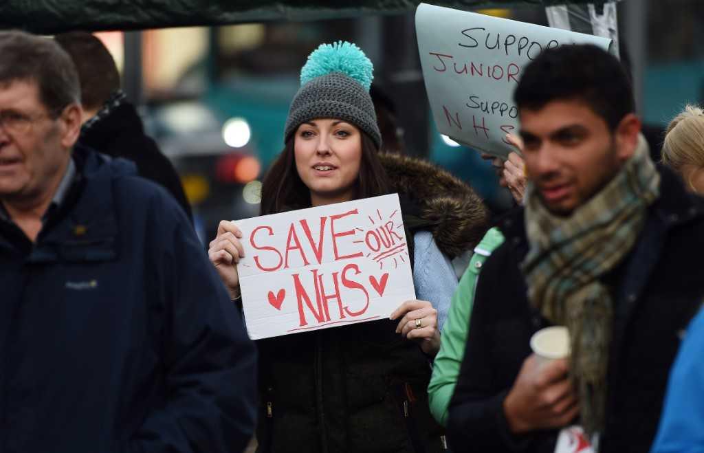 Demonstrators hold placards during a protest outside the Royal Liverpool University Hospital in Liverpool, north west England, on Jan 12, 2016, during a strike by junior doctors. Photo: AFP 