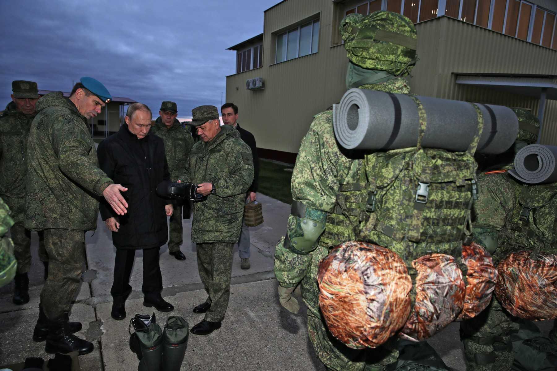 This photograph taken on Oct 20, 2022, shows Russian President Vladimir Putin and Defence Minister Sergei Shoigu inspecting equipment as they meet with soldiers during a visit at a military training centre of the Western Military District for mobilised reservists, outside the town of Ryazan. Photo: AFP