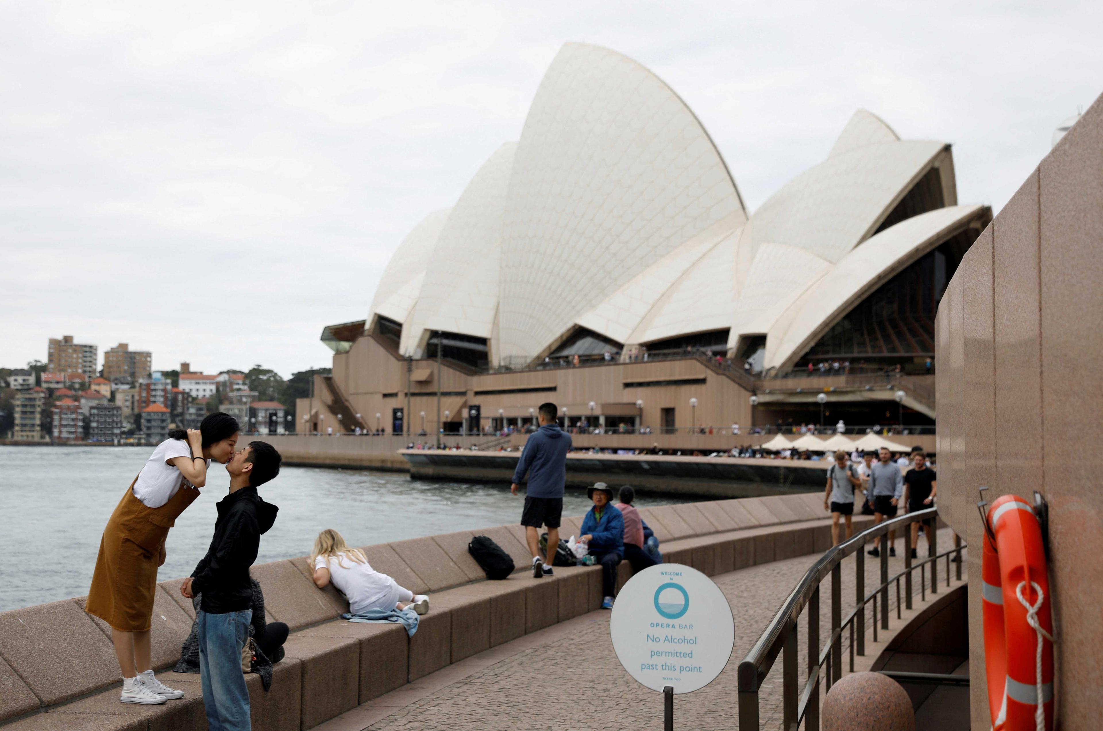 Chinese tourists pose for a photographer near the Sydney Opera House, Australia April 18, 2018. Photo: Reuters
