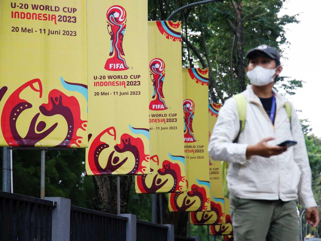 A man walks past Fifa U-20 World Cup banners outside Indonesia's football federation office, after the country was dropped as host of the under-20 World Cup following outrage among politicians in the predominantly Muslim country about Israel's participation, in Jakarta, March 30. Photo: Reuters