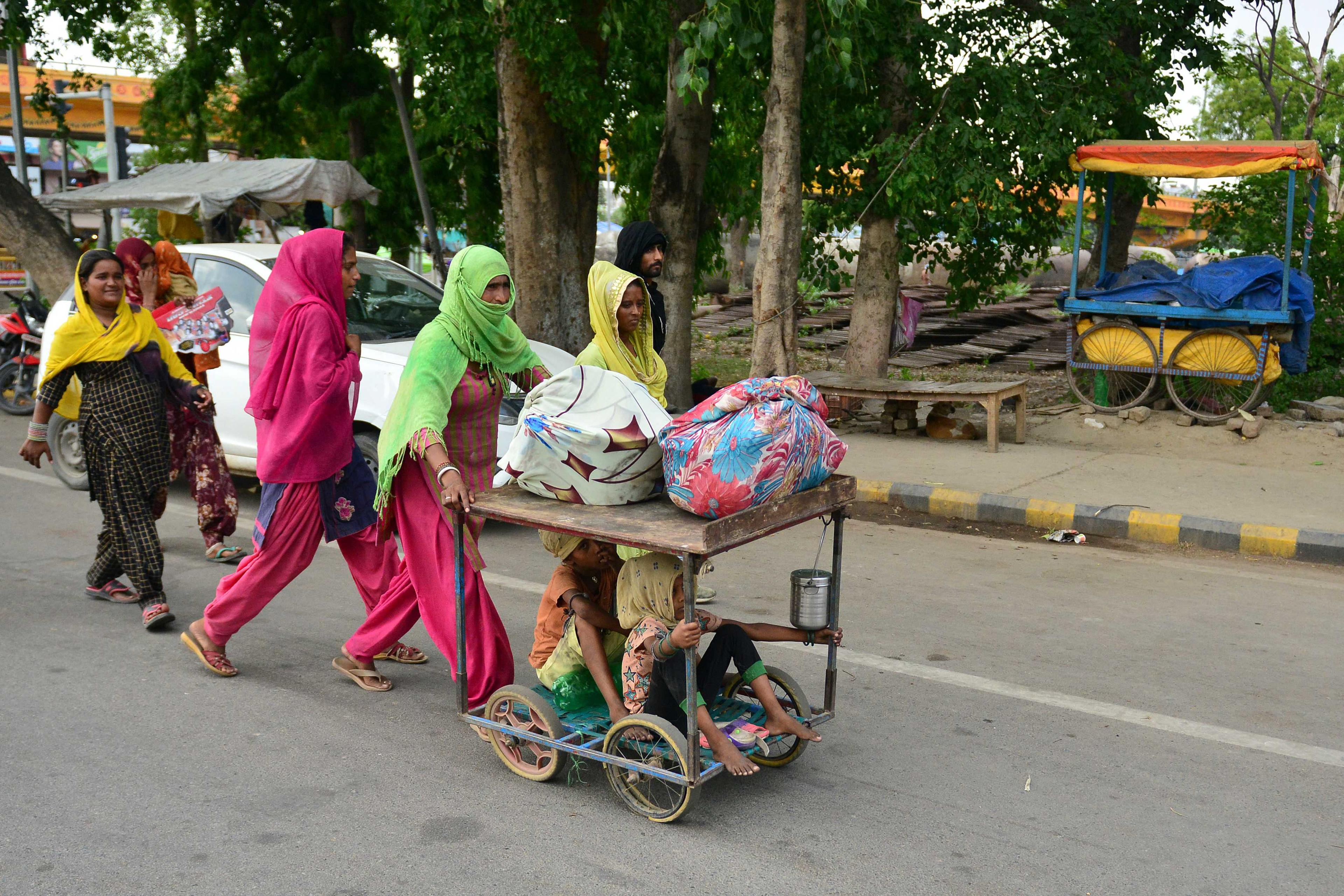 Migrants labourers walk on a road as they wait for transportation to go back to their hometowns in Allahabad on May 24, 2020. Photo: AFP