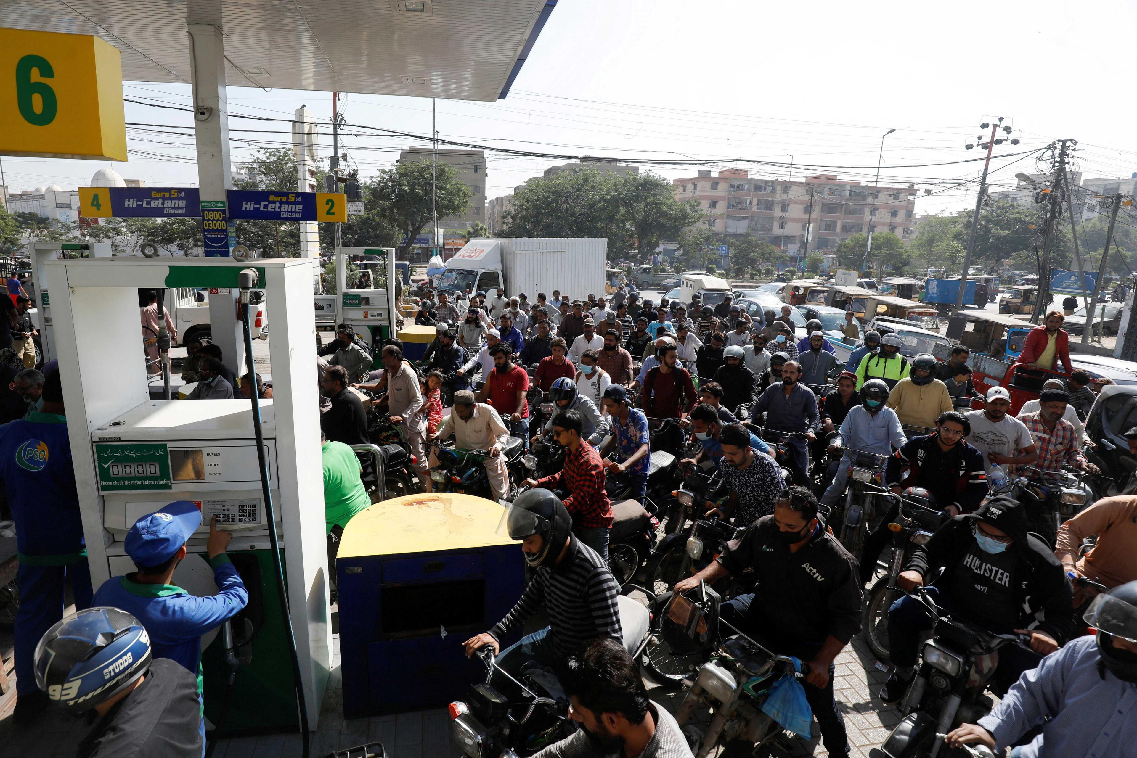 People on motorcycles wait for their turn to get petrol at a petrol station, after Pakistan Petroleum Dealers Association (PPDA) announced a countrywide strike, in Karachi, Pakistan, Nov 25, 2021. Photo: Reuters