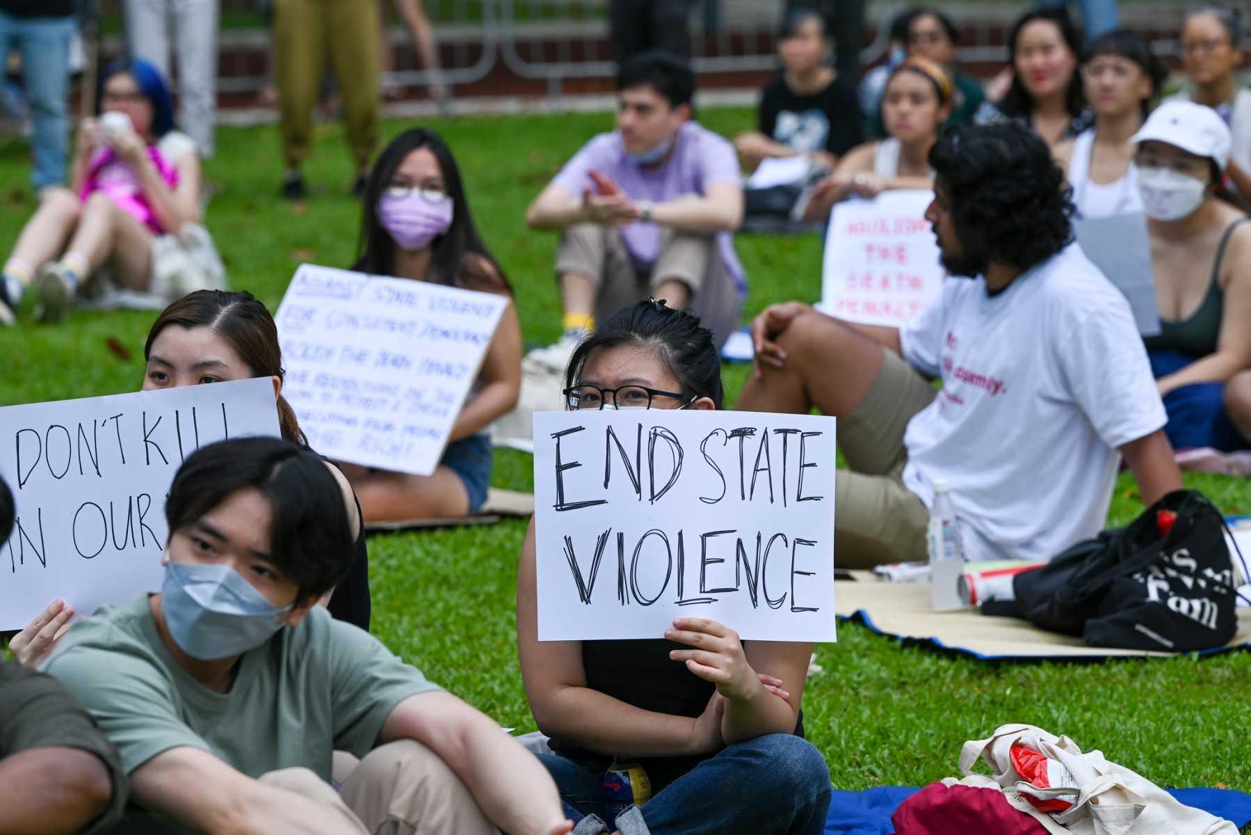 Protesters hold signs during a demonstration against the death penalty at the Speakers' Corner in Singapore on April 3, 2022. Photo: AFP

