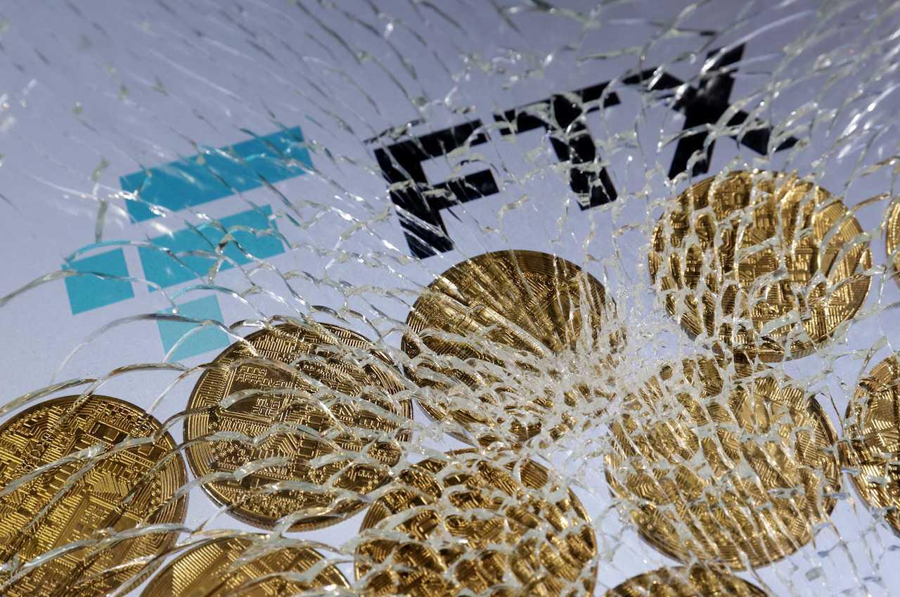 An FTX logo and a representation of cryptocurrencies are seen through broken glass in this illustration taken Dec 13, 2022. Photo: Reuters