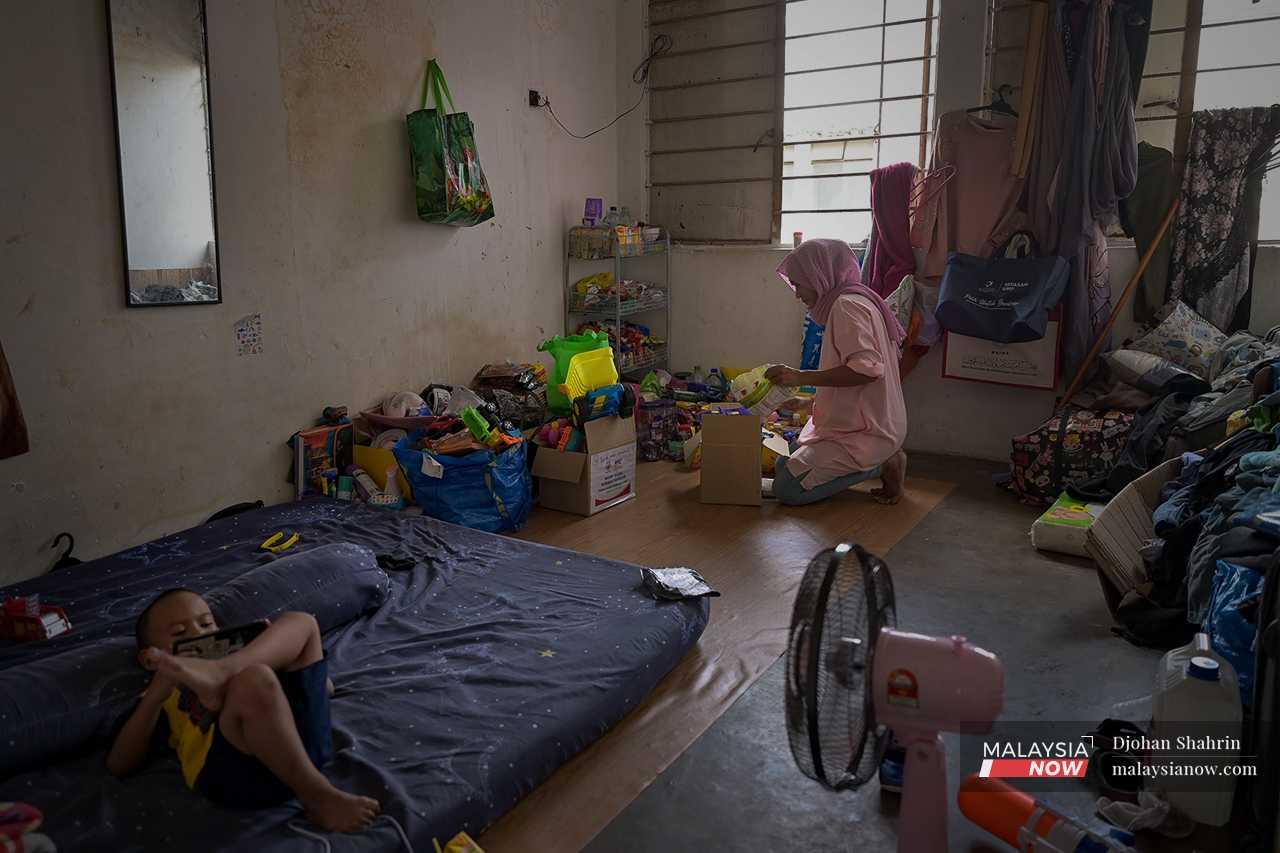 Their belongings, including the food packs given through acts of charity, are arranged in piles in the corners of their room which they rent for RM600 a month. 