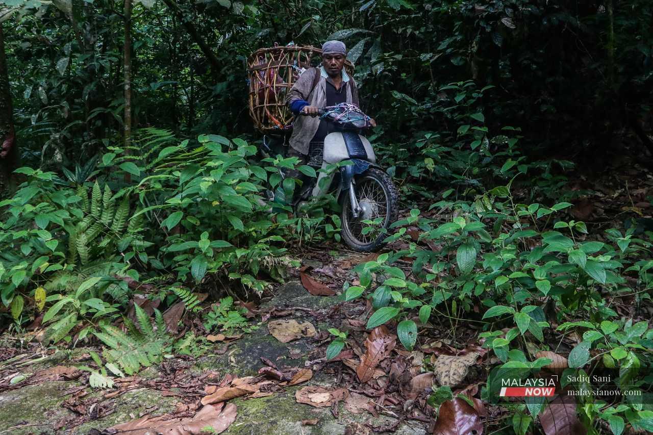 Back on his motorcycle, he carefully navigates his way out of the jungle. 