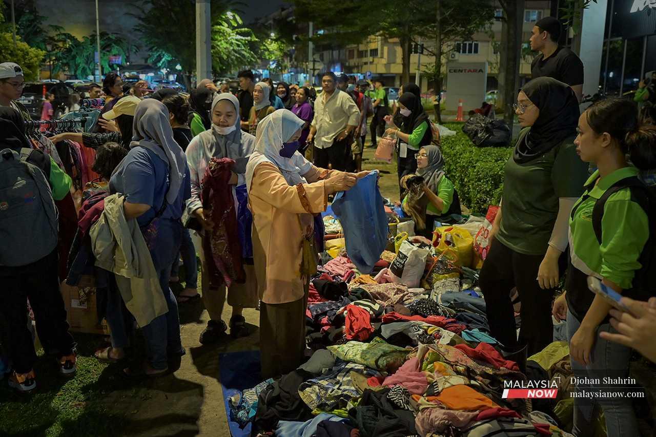 The clothing is distributed freely to those in need, with volunteers on hand to help them sort through the piles. 