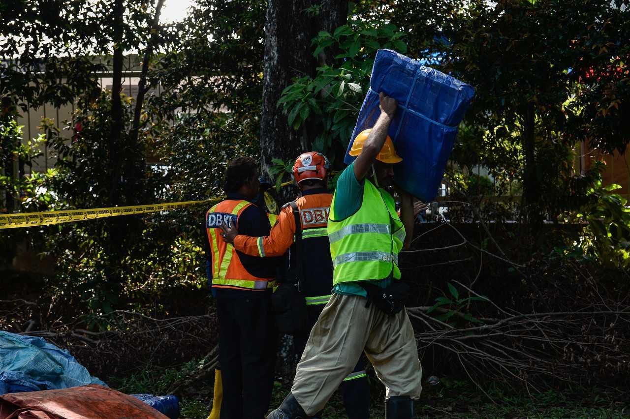 Contractors carrying out repair works following the landslide that struck the grounds of the Malaysian Anti-Corruption Academy yesterday. Photo: Bernama