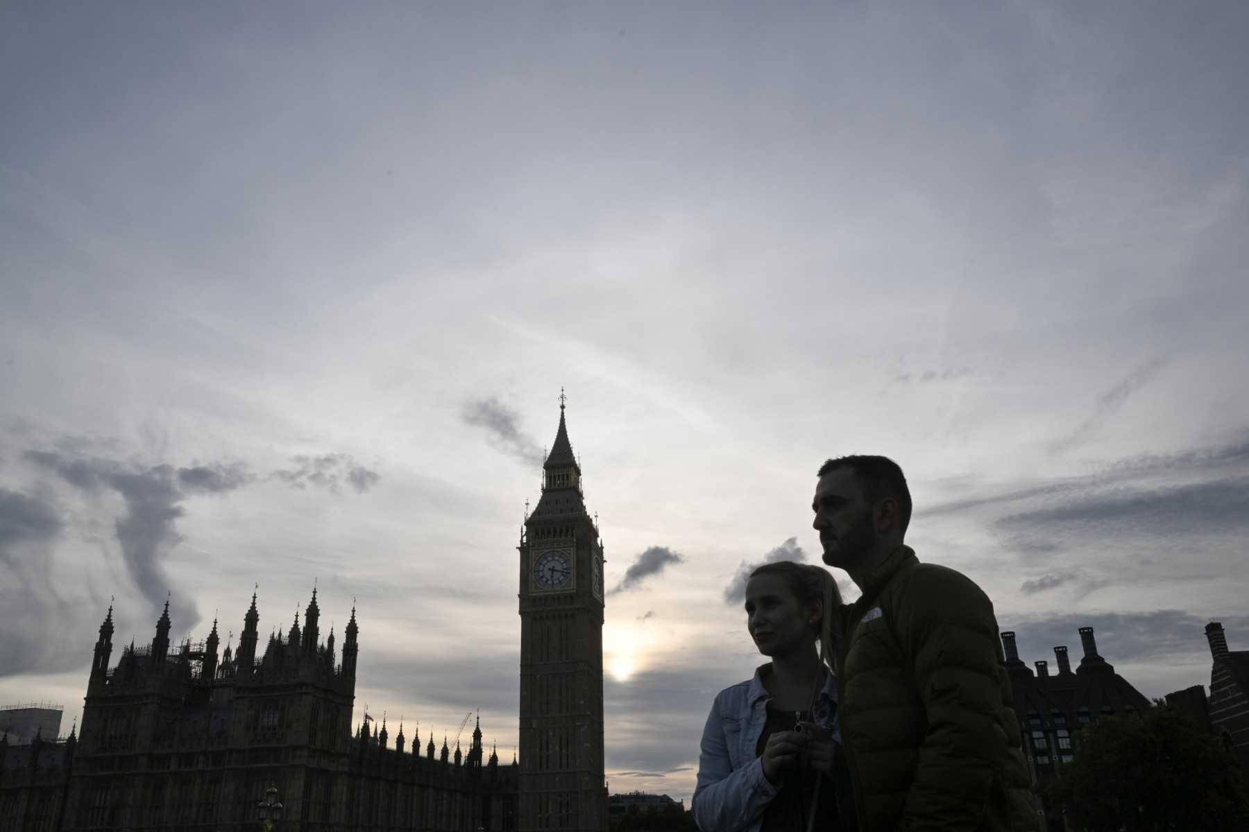 Pedestrians look on with the Big Ben in the background in London on Sept 11, 2022. Photo: AFP
