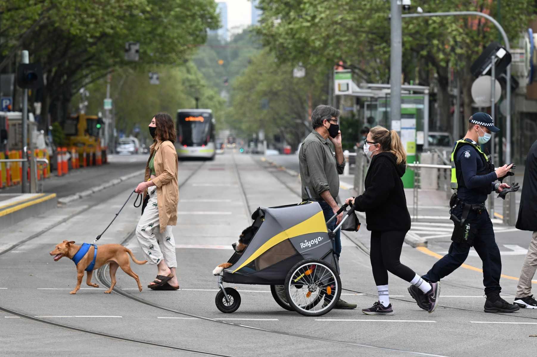 People walk their dogs in Melbourne, Australia on Sept 30, 2021. Photo: AFP 