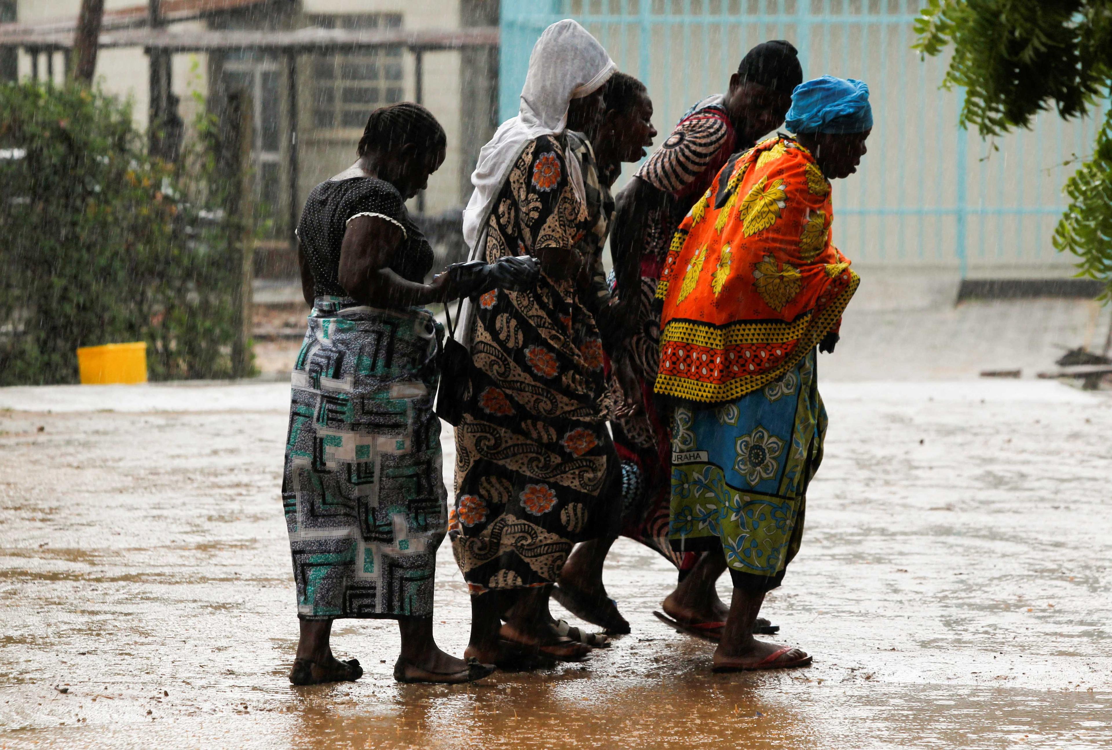 Relatives of the followers of a Christian cult named as Good News International Church mourn as they walk in the rain outside the Malindi sub district hospital mortuary in Malindi, Kilifi county, Kenya April 27. Photo: Reuters