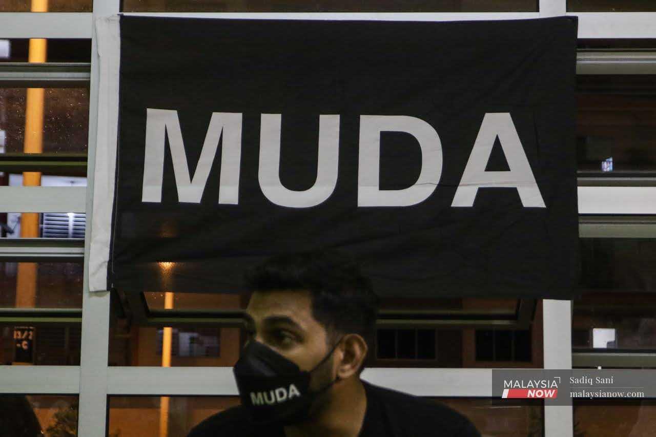 A Muda flag hangs in the background ahead of the Johor state election in March 2022.