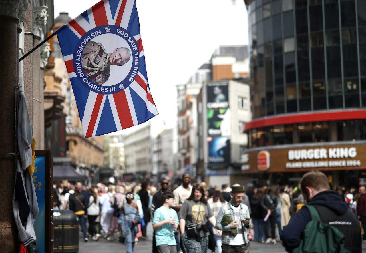 A King Charles souvenir flag hangs outside a shop ahead of the coronation of King Charles in London, Britain, April 30. Photo: Reuters