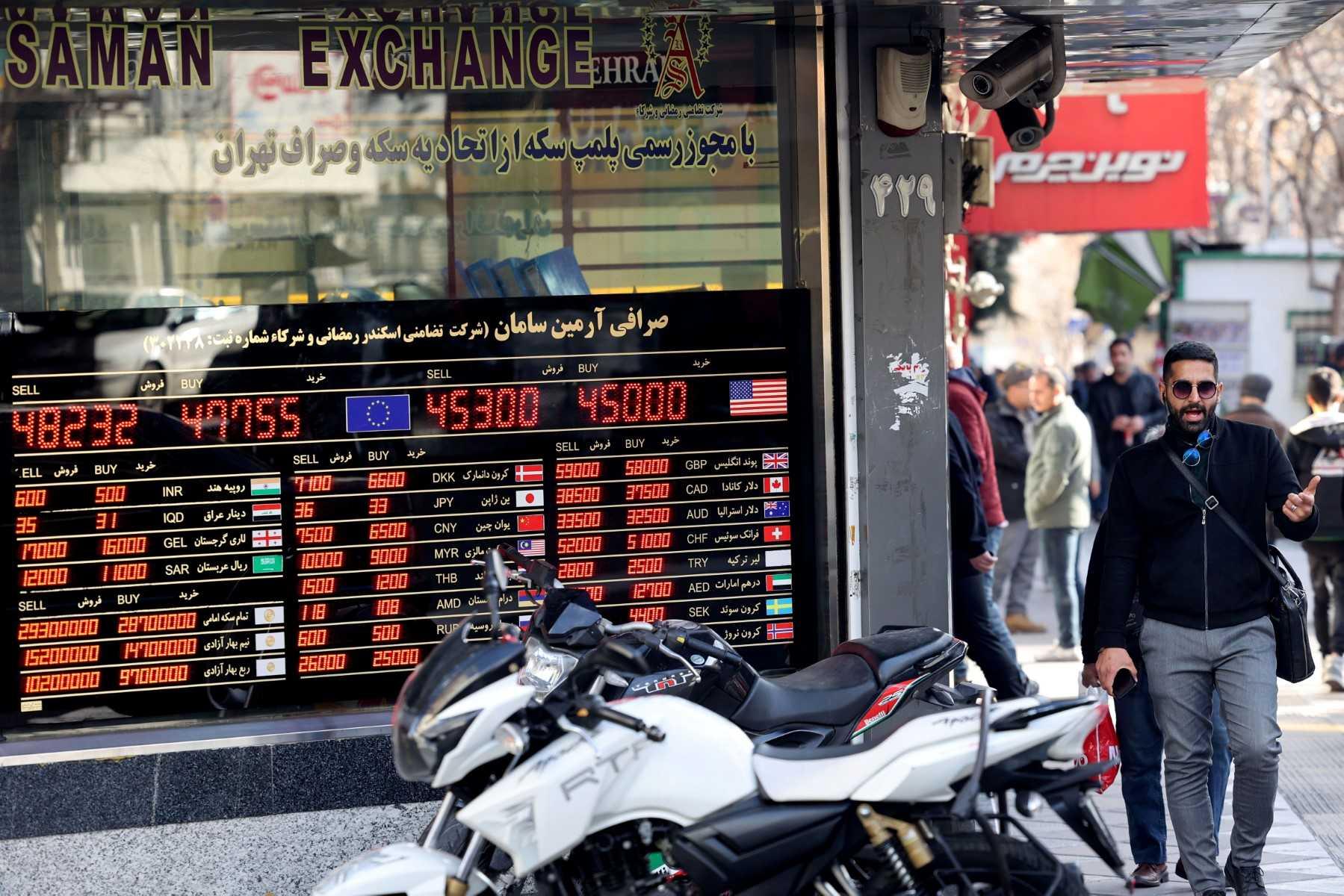 A man walks past a currency exchange shop in Tehran on Feb 21. Photo: AFP