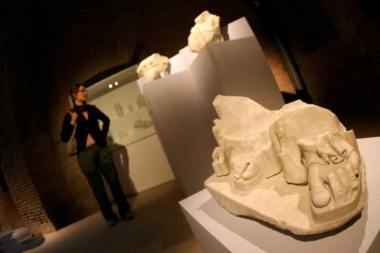 A visitor admires some ancient roman marble pieces inside the new renovated Forum of Trajan in Rome during it's inauguration, 17 Oct 2007. Photo: AFP