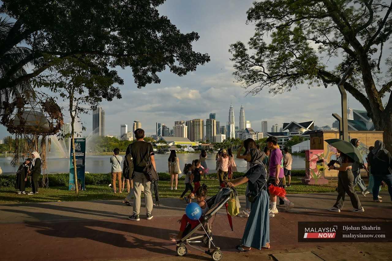 Families stroll about at Tasik Titiwangsa in Kuala Lumpur. 
