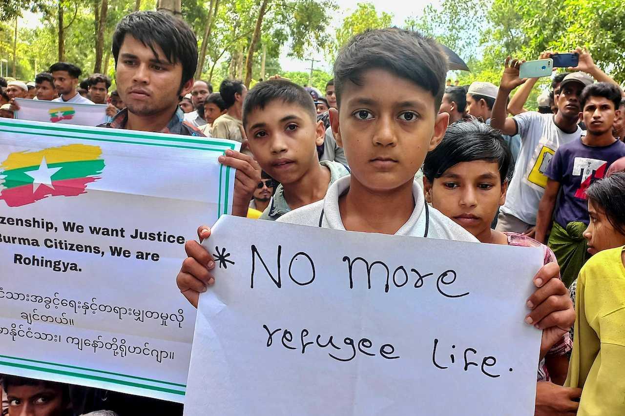 Rohingya refugee children hold placards as they gather at the Kutupalong refugee camp to mark the fifth anniversary of their fleeing from neighbouring Myanmar to escape a military crackdown in 2017, in Cox's Bazar, Bangladesh, Aug 25, 2022. Photo: Reuters