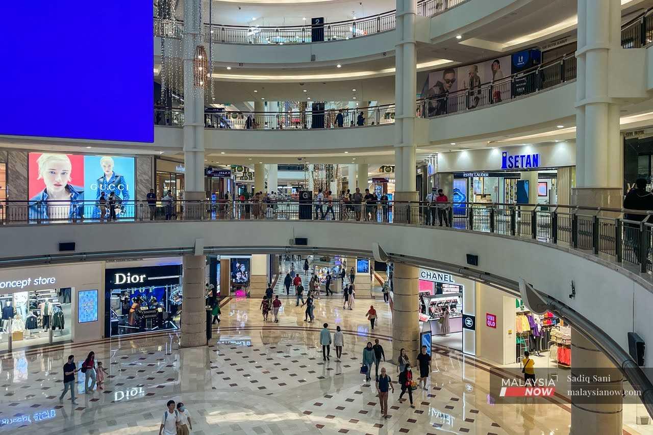 Shoppers stroll around a mall in Kuala Lumpur. 