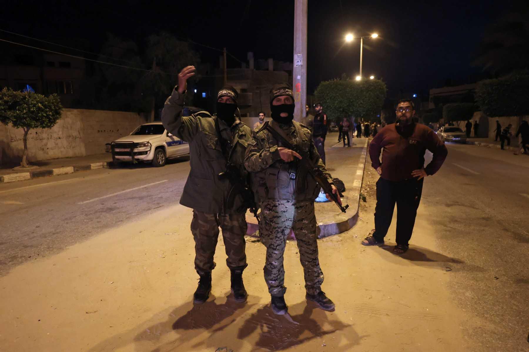 Palestinian Islamic Jihad members gather near a damaged house after an Israeli airstrike in Rafah refugee camp, southern Gaza Strip, Palestinian Territories on May 9. Photo: AFP